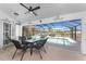 Outdoor dining area on the patio overlooking a refreshing screened-in pool at 311 Boundary Blvd, Rotonda West, FL 33947