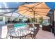 Relaxing screened-in pool with outdoor seating area and dining set, perfect for entertaining at 311 Boundary Blvd, Rotonda West, FL 33947