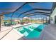 Large screened-in pool with comfortable lounge chairs and inflatable floats on the surface at 311 Boundary Blvd, Rotonda West, FL 33947