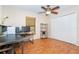 Comfortable bedroom featuring wood-look floors, neutral walls, a ceiling fan, and a storage closet at 3593 Birmingham Ln, North Port, FL 34288