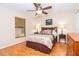 Comfortable bedroom with a queen bed, wood floor, and warm, inviting decor at 3593 Birmingham Ln, North Port, FL 34288