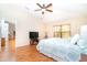 Spacious bedroom with a ceiling fan, wood floors, and natural light at 3593 Birmingham Ln, North Port, FL 34288