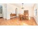 Bright dining room featuring wood floors, matching table and chairs, and traditional chandelier at 3593 Birmingham Ln, North Port, FL 34288