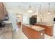 Spacious kitchen with a large island, granite countertops, stainless steel sink, and ample storage space at 3593 Birmingham Ln, North Port, FL 34288