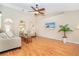 Bright living room featuring wood-look floors, neutral walls, vaulted ceiling, and a ceiling fan at 3593 Birmingham Ln, North Port, FL 34288