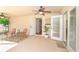 Comfortable covered patio with ceiling fans, seating area, and direct access to the interior at 3593 Birmingham Ln, North Port, FL 34288