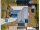 Bird's eye view of single Gathering home showcasing metal roof, driveway, and fenced in yard at 360 E Wentworth Cir, Englewood, FL 34223