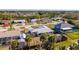 An aerial view of the home and neighborhood featuring mature landscaping and metal roofs at 360 E Wentworth Cir, Englewood, FL 34223