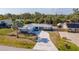 An aerial view of the home showcasing its lush landscaping, metal roof and decorative driveway at 360 E Wentworth Cir, Englewood, FL 34223