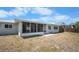 Backyard featuring a screened lanai and green space. Perfect for outdoor entertaining at 360 E Wentworth Cir, Englewood, FL 34223