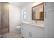 Bathroom featuring a vanity, mirror, toilet, and shower with tile surround at 360 E Wentworth Cir, Englewood, FL 34223