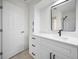 Beautiful bathroom featuring a white vanity with modern hardware, a mirror, and a door at 360 E Wentworth Cir, Englewood, FL 34223