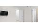 Bedroom featuring a wall-mounted TV, and doorway to hallway with multiple closets at 360 E Wentworth Cir, Englewood, FL 34223