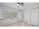 Well-lit bedroom featuring windows and a double door closet at 360 E Wentworth Cir, Englewood, FL 34223