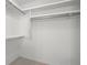 Bright, walk-in closet featuring ample storage with multiple shelves and clothing rods at 360 E Wentworth Cir, Englewood, FL 34223