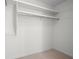 Bright, walk-in closet featuring ample storage with multiple shelves and clothing rods at 360 E Wentworth Cir, Englewood, FL 34223