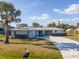Charming home with modern features, lush landscaping, a mailbox, and a concrete driveway at 360 E Wentworth Cir, Englewood, FL 34223