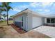 Charming home featuring a two-car garage, stone accents, fresh landscaping and a concrete driveway at 360 E Wentworth Cir, Englewood, FL 34223