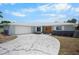Beautifully renovated single-story home with a modern driveway, a two-car garage, and a landscaped yard at 360 E Wentworth Cir, Englewood, FL 34223