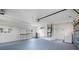 Spacious garage with washer and dryer, ample storage, and work area with overhead lighting at 360 E Wentworth Cir, Englewood, FL 34223