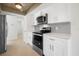 Modern kitchen featuring stainless steel appliances, bright white cabinets and tile flooring at 360 E Wentworth Cir, Englewood, FL 34223