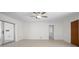 Open living room with light-colored walls, wood-look floors, and sliding glass doors to the outside at 360 E Wentworth Cir, Englewood, FL 34223