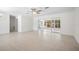 A bright and airy living room featuring sleek sliding doors and light-colored tile flooring at 360 E Wentworth Cir, Englewood, FL 34223