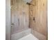 Walk-in shower featuring a built-in bench and multiple shower heads at 360 E Wentworth Cir, Englewood, FL 34223