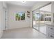 Bright sunroom featuring sliding glass doors that provide lots of natural light and three wall shelves at 360 E Wentworth Cir, Englewood, FL 34223