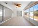 Bright sunroom with tile floors, large windows to the backyard, and an exterior shed at 360 E Wentworth Cir, Englewood, FL 34223
