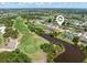 Aerial view of the home near a golf course, water features and community at 39 Medalist Ln, Rotonda West, FL 33947
