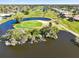 Scenic aerial view of a golf course with lush green fairways, water hazards, and residential homes at 39 Medalist Ln, Rotonda West, FL 33947