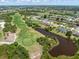 Aerial view of the home near a golf course, water features and community at 39 Medalist Ln, Rotonda West, FL 33947