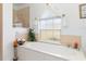 Bathroom features a large soaking tub and garden window with natural light at 39 Medalist Ln, Rotonda West, FL 33947