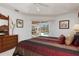 Well-lit bedroom with slider door leading to the screened in patio at 39 Medalist Ln, Rotonda West, FL 33947