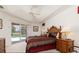 Comfortable bedroom with a view of the pool, featuring a ceiling fan, a bed, and wood furnishings at 39 Medalist Ln, Rotonda West, FL 33947