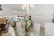 Bright dining room featuring a glass table, chandelier, and sliding doors to the outdoor area at 39 Medalist Ln, Rotonda West, FL 33947