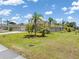 Sprawling ranch-style home with lush tropical landscaping and mature palms on a well-maintained lawn at 39 Medalist Ln, Rotonda West, FL 33947