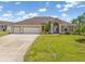 Charming single-Gathering home with a large three-car garage and a beautifully landscaped front yard at 39 Medalist Ln, Rotonda West, FL 33947