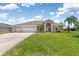 Attractive single-story home boasting a three-car garage, well-manicured lawn, and inviting curb appeal at 39 Medalist Ln, Rotonda West, FL 33947