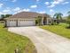 Attractive home with a three-car garage and long driveway at 39 Medalist Ln, Rotonda West, FL 33947