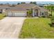Beautiful home with a three-car garage, nice lawn and landscaping at 39 Medalist Ln, Rotonda West, FL 33947