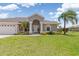 Charming home with manicured lawn, well-maintained landscaping and a two car garage at 39 Medalist Ln, Rotonda West, FL 33947