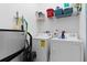 Bright laundry room with washer, dryer, storage, and cleaning supplies for easy chore days at 39 Medalist Ln, Rotonda West, FL 33947