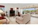 Bright and airy living room with sliding glass doors to pool and comfortable furnishings at 39 Medalist Ln, Rotonda West, FL 33947