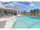 Stunning pool featuring clear blue water, a screened enclosure, and plenty of space for outdoor gatherings at 39 Medalist Ln, Rotonda West, FL 33947