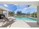 Serene swimming pool with an enclosed screen, outdoor seating, and views of the surrounding landscape at 39 Medalist Ln, Rotonda West, FL 33947