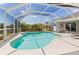 Relaxing screened-in pool with clear blue water and plenty of space for lounging at 39 Medalist Ln, Rotonda West, FL 33947