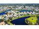 Expansive aerial view of a lakeside community with numerous homes and well-maintained surroundings at 4115 Hemingway Dr, Venice, FL 34293