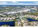 Overhead aerial view showcases homes near retail areas, with one property outlined in orange at 4115 Hemingway Dr, Venice, FL 34293